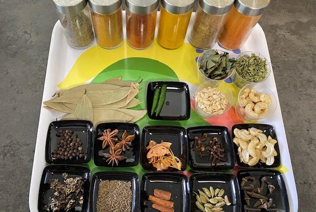 A tray with whole and freshly ground spices for garam masala