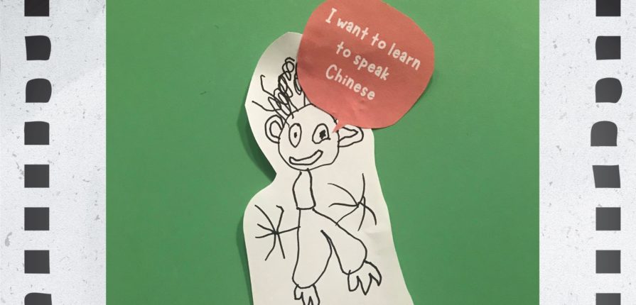 Child's self-portrait with the text "I want to learn to speak Chinese"