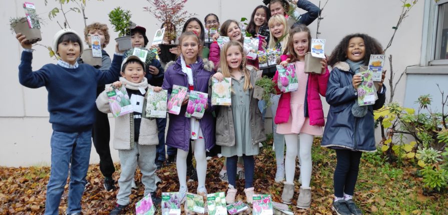 Nature Club students holding the bulbs and plants purchased from the proceeds of their annual pumpkin sale