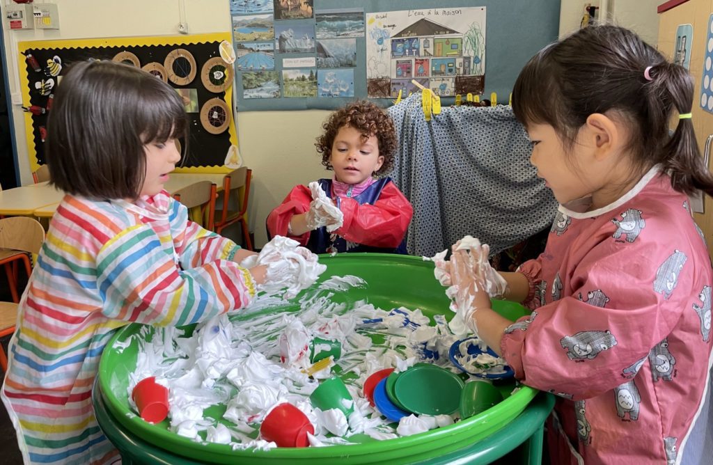 3 students playing with foam as a form of sensory play