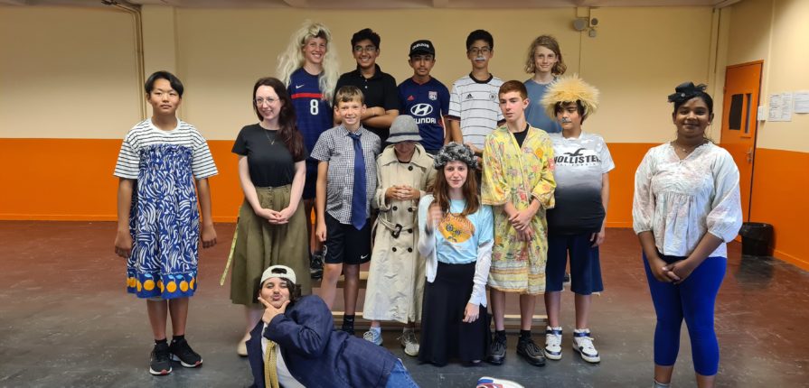 Grade 7 students posing for a group photo in their costumes