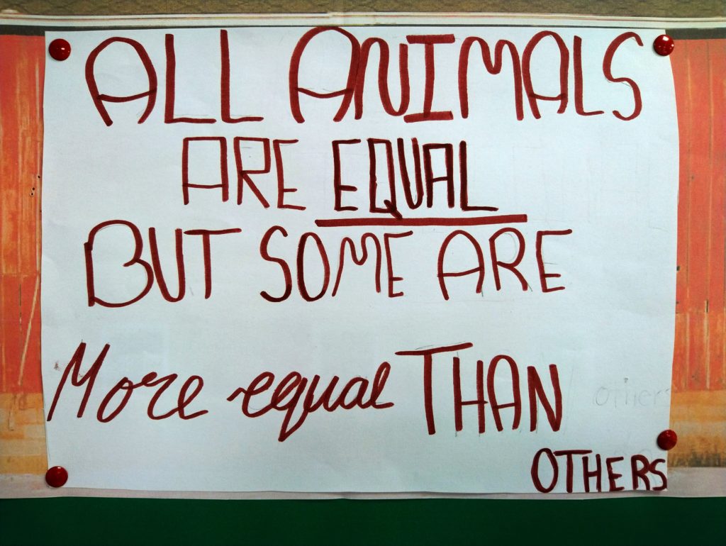 Sign reading: "All Animals are Equal, but Some Are More Equal Than Others"