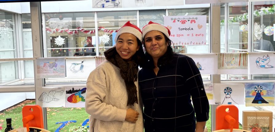 Two parents wearing Santa hats