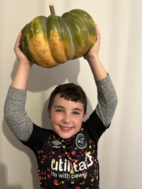 boy holding a pumpkin