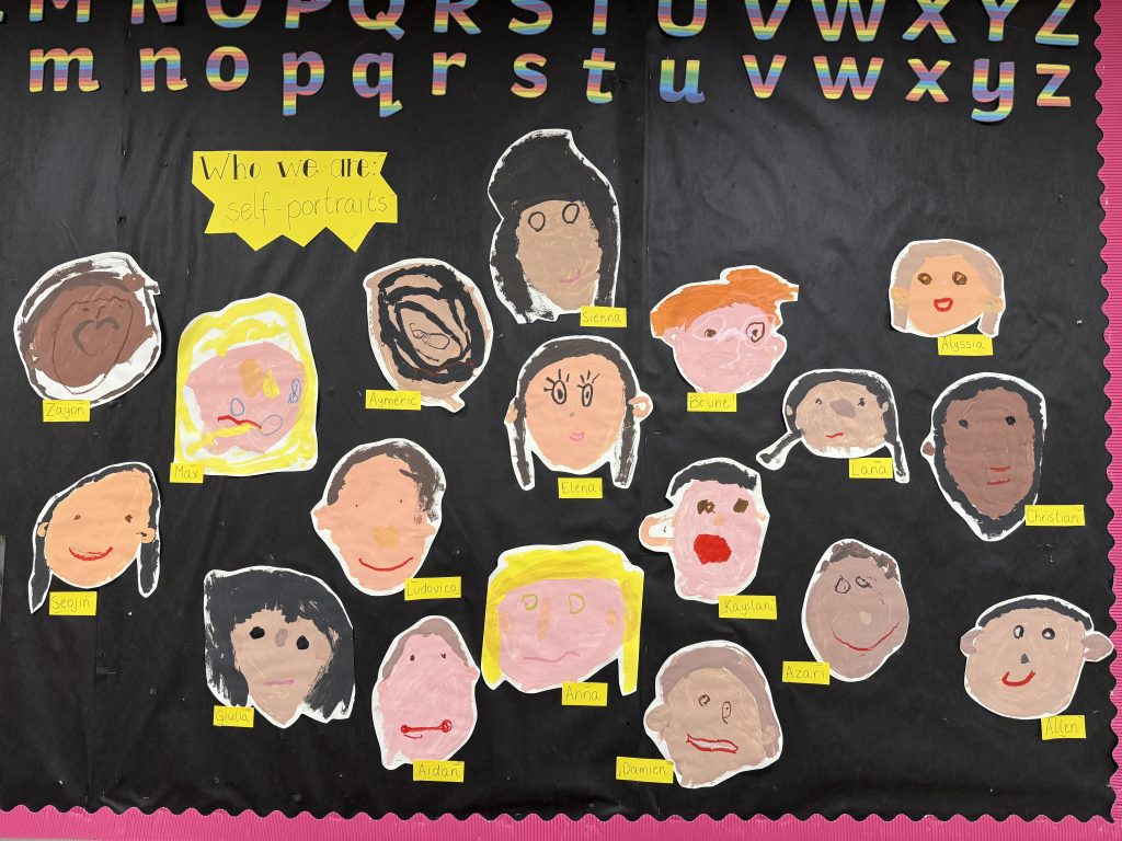 Paper self portraits on a black background