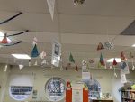 Handmade paper Christmas decorations hanging from the ceiling of the ISL Library