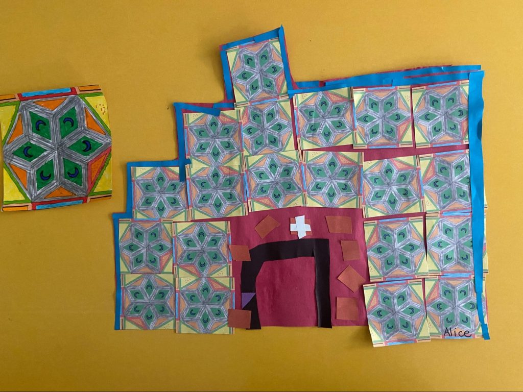 a blue and red tiled house made from paper