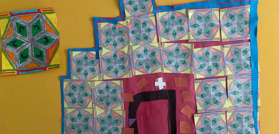 a blue and red tiled house made from paper